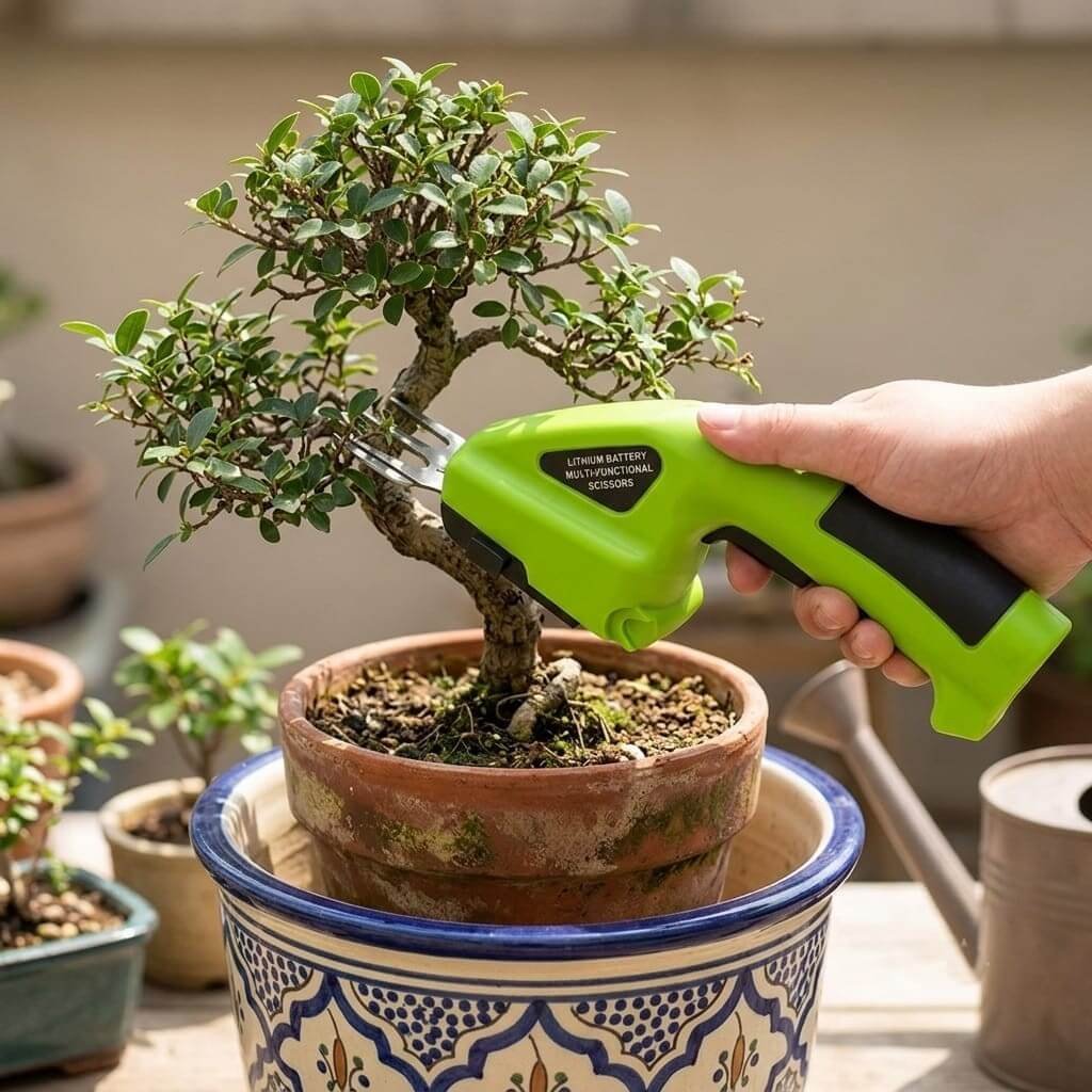 Cordless Grass Shears In Use - Bonsai Trimming Hand using cordless grass and hedge shears to trim a bonsai tree in a terracotta pot