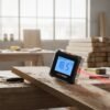Digital Inclinometer In Use - Woodworking Workshop Digital inclinometer measuring 18.5 degree angle on wood plank in carpentry workshop