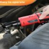 Hand using cordless electric ratchet wrench on car engine bolt for easy automotive repair