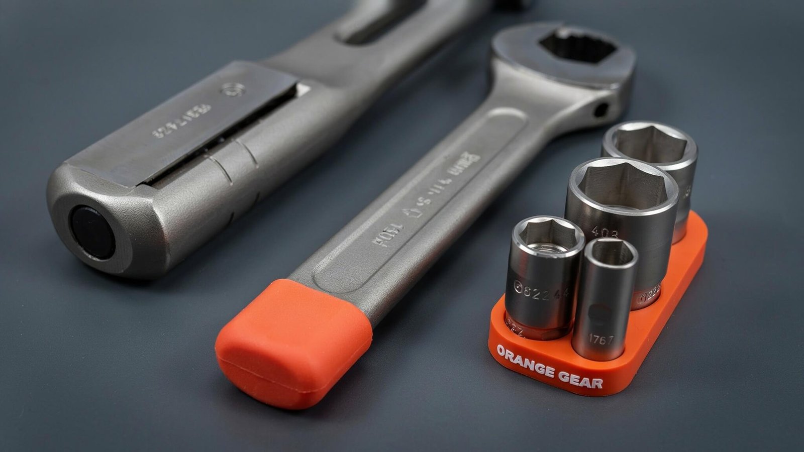 Adjustable wrench and socket set on dark background